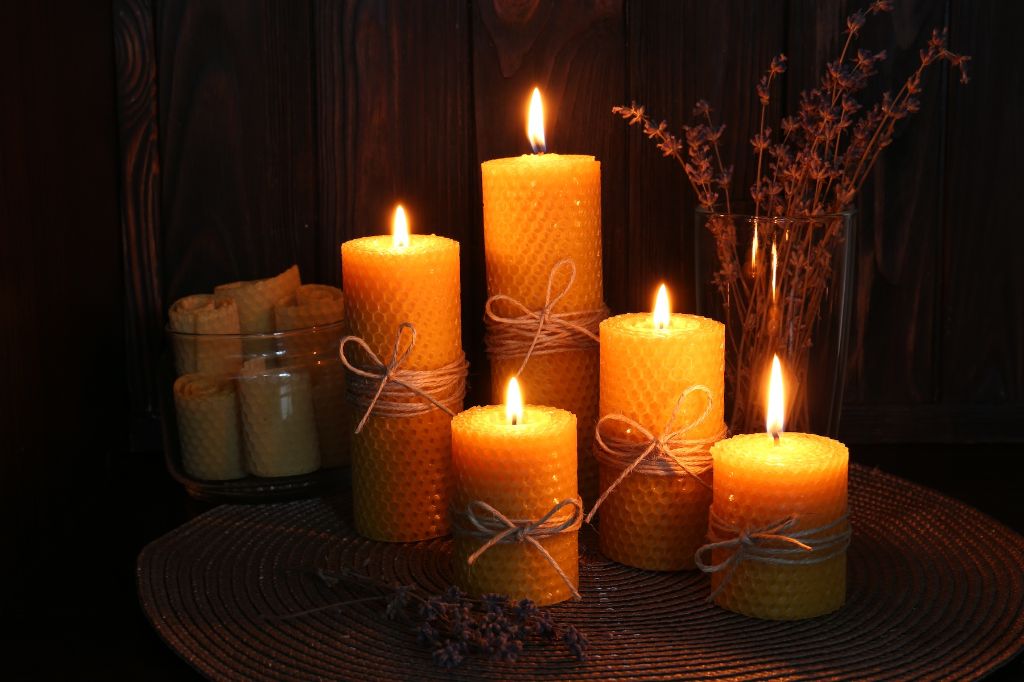 beeswax candles on a wood table.