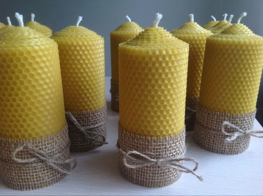 burning beeswax candle with honeycomb