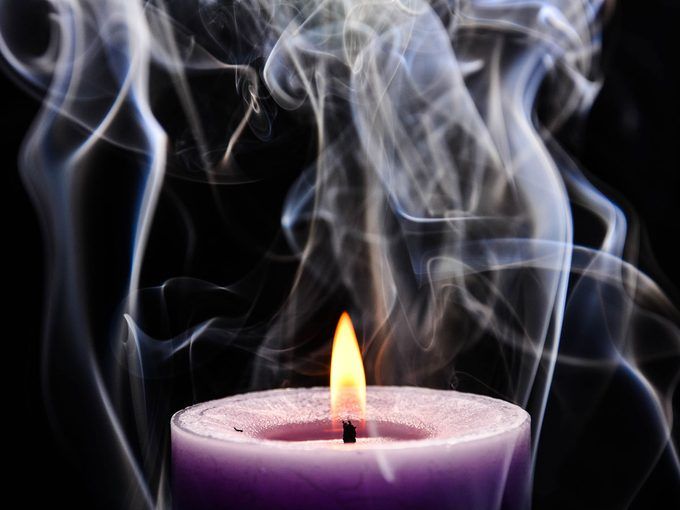 burning candle emitting smoke