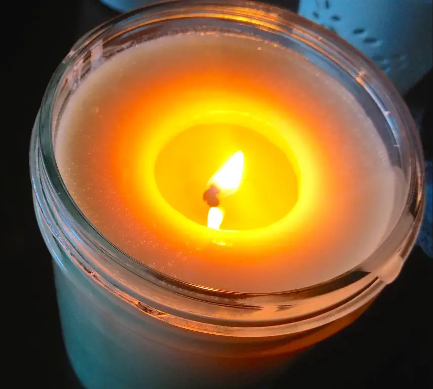 candle with extreme tunneling and warped sides indicating it should be replaced