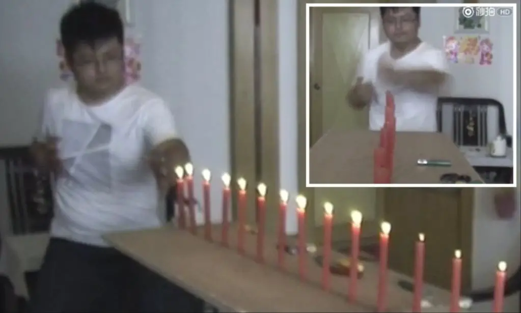 person blowing out candle with air ventilation
