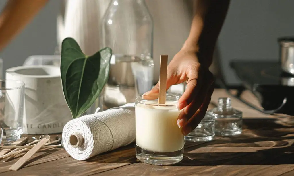 person pouring soy wax candles