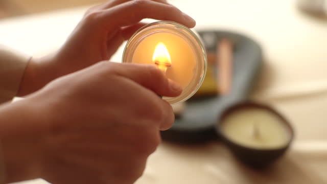 person smelling a handcrafted candle