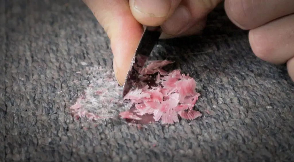 scraping candle wax with knife