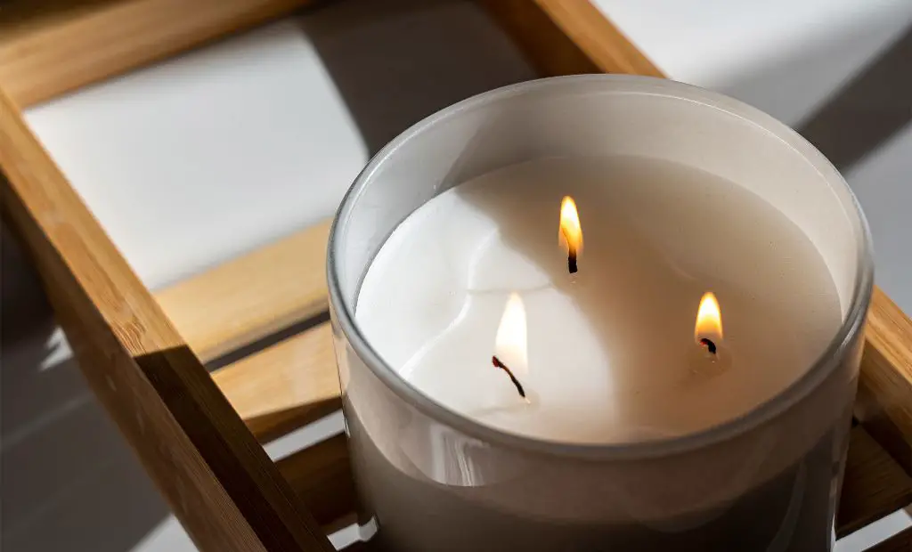 a burning candle with wax melting into a pool