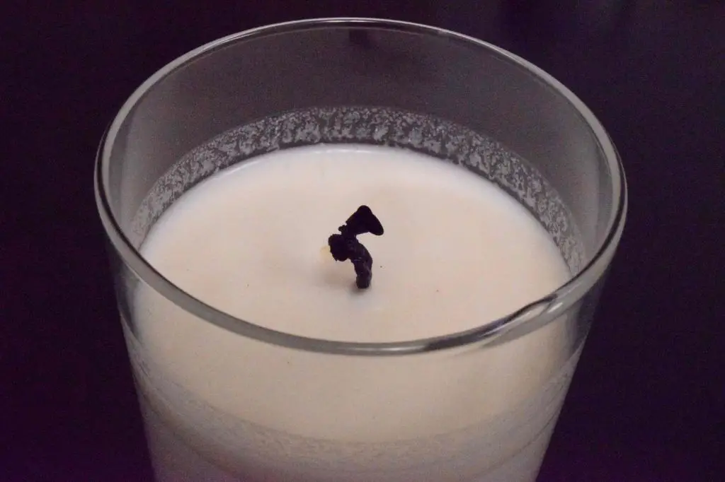 a candle wick with blackened mushroom shaped tip that needs trimming.