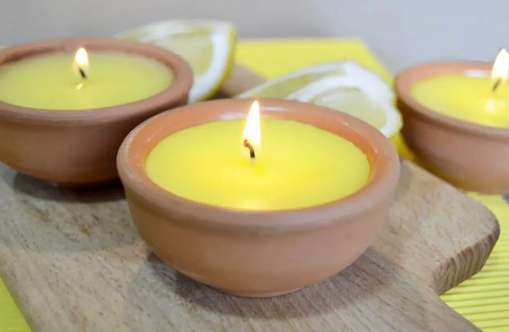 a citronella candle burning, with the claim that it repels mosquitos.