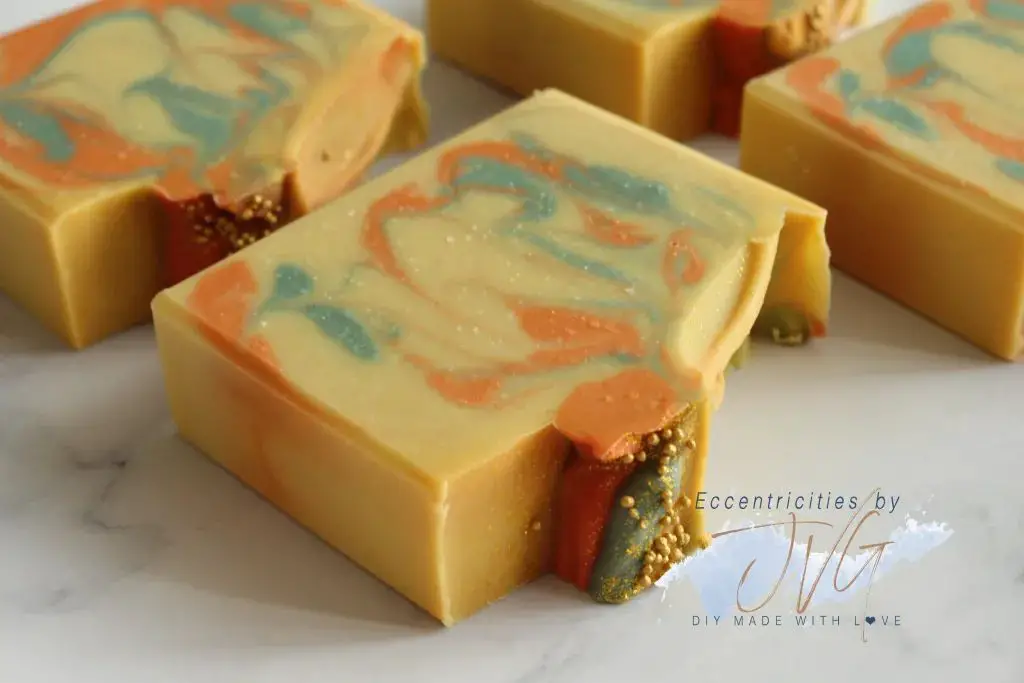 a close up photo of brightly colored stripes of melt and pour soap base before swirling into intricate patterns.