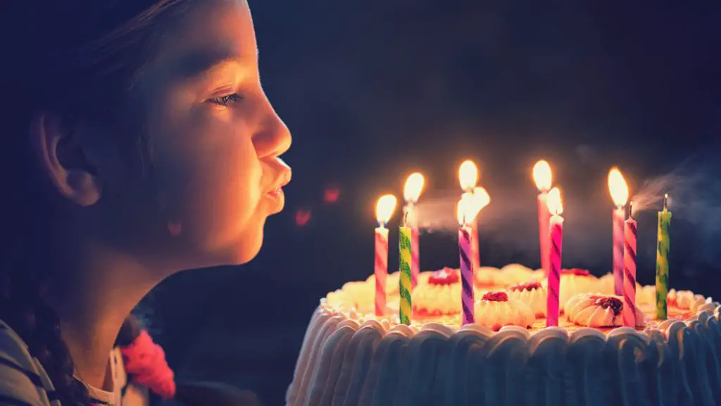 a person blowing out a candle