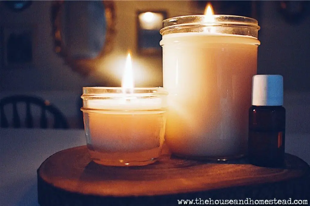 a person pouring natural soy wax into a jar to make a scented candle