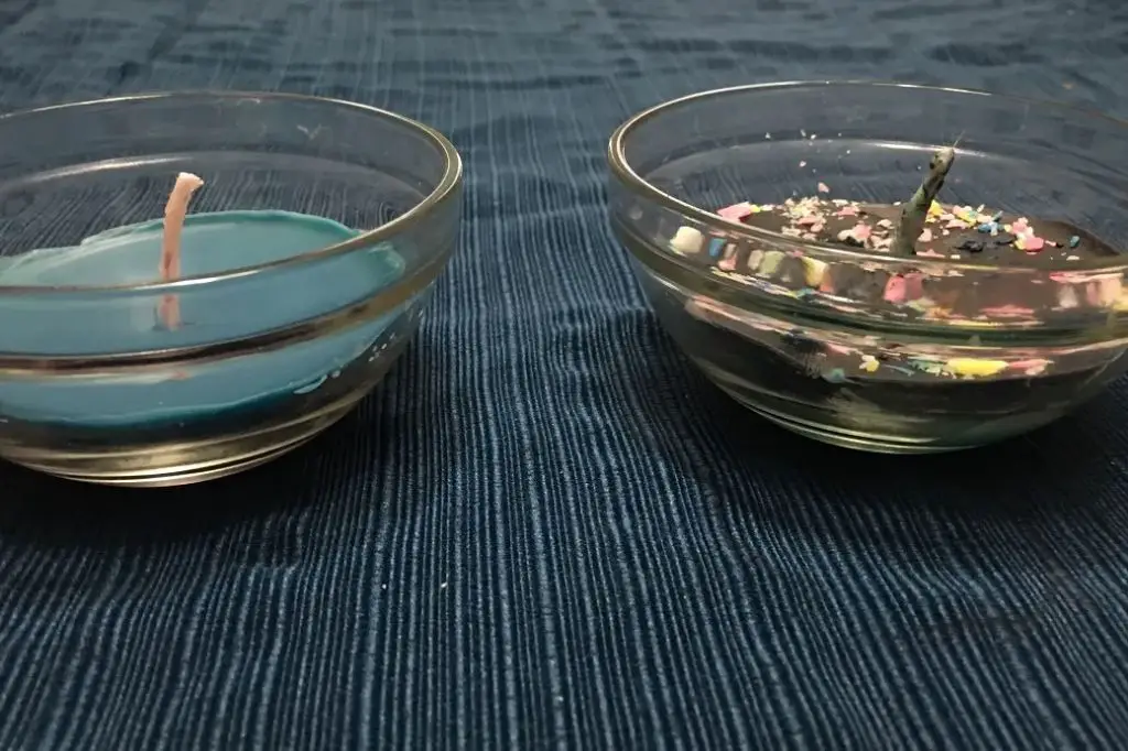 a person selecting a small, plain candle to melt in a microwave