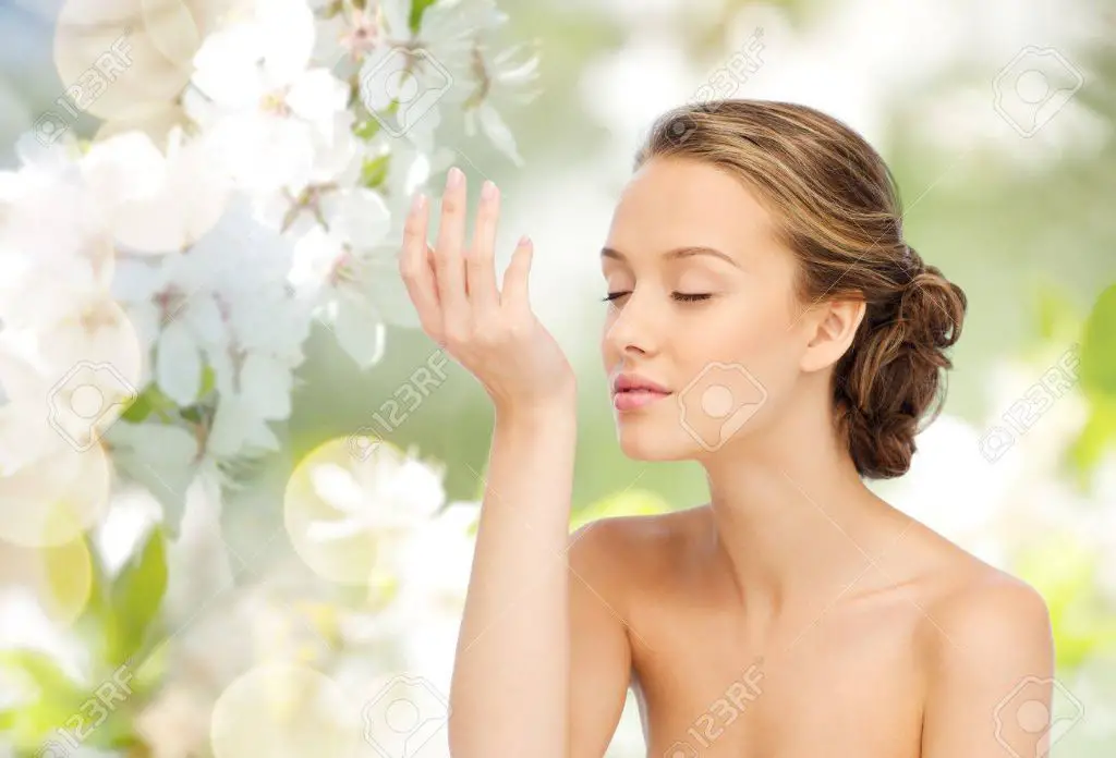 a person smelling a cherry blossom fragrance.