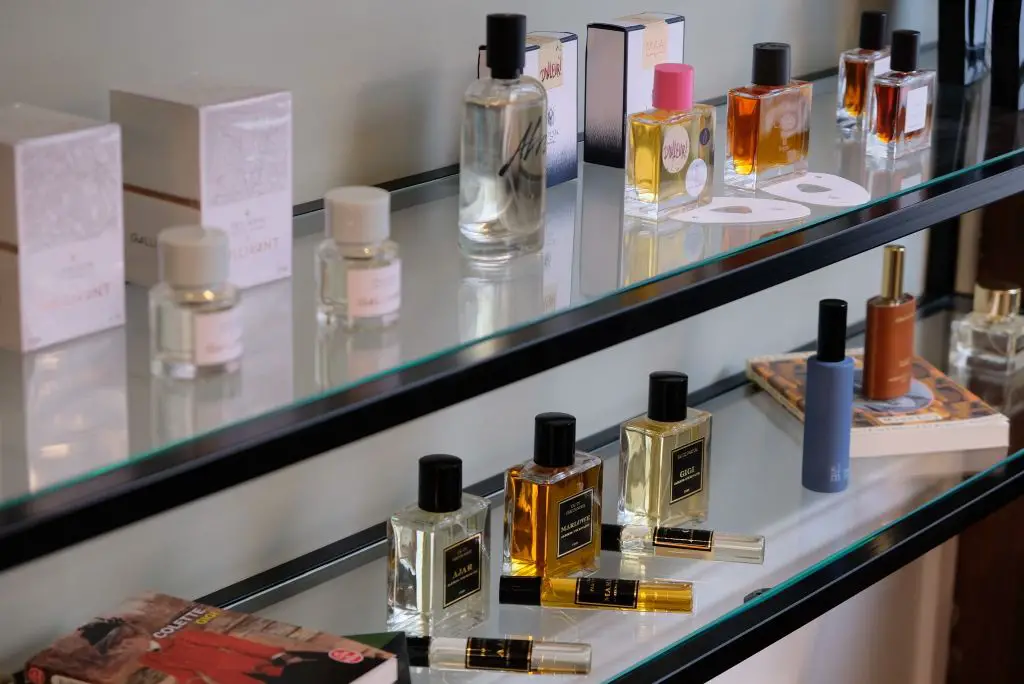 a person smelling various perfume samples at a niche perfumery