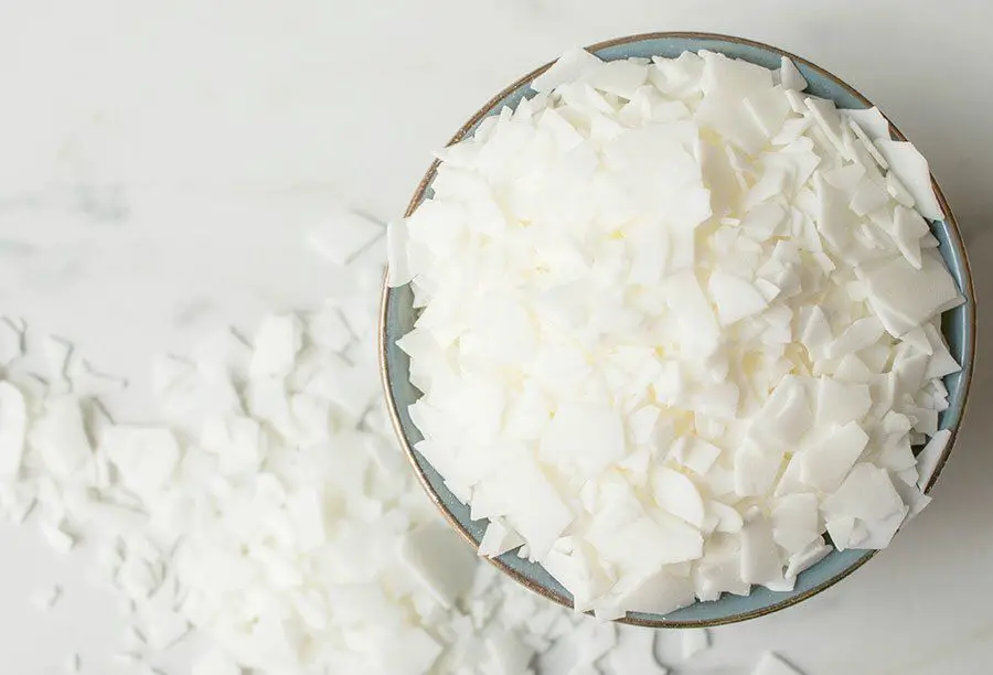 a photo of soy wax flakes being blended into liquid paraffin wax