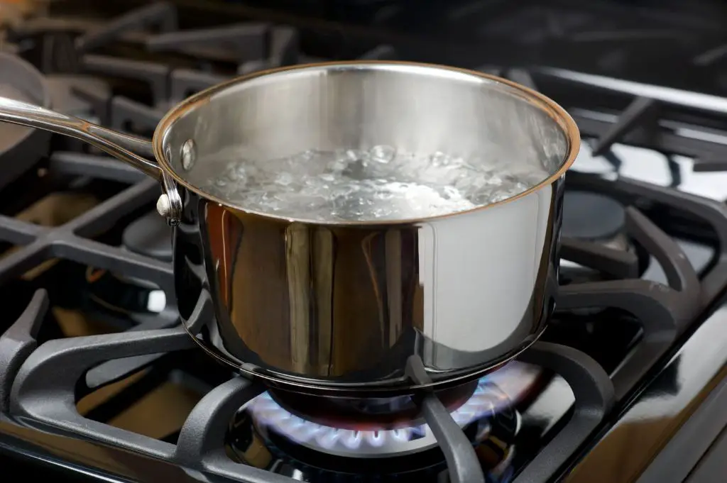 a pot of water boiling on a stove.
