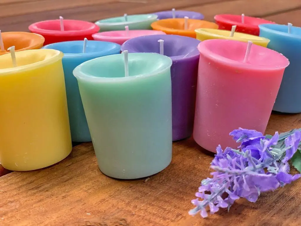 a row of votive candles with different scent options