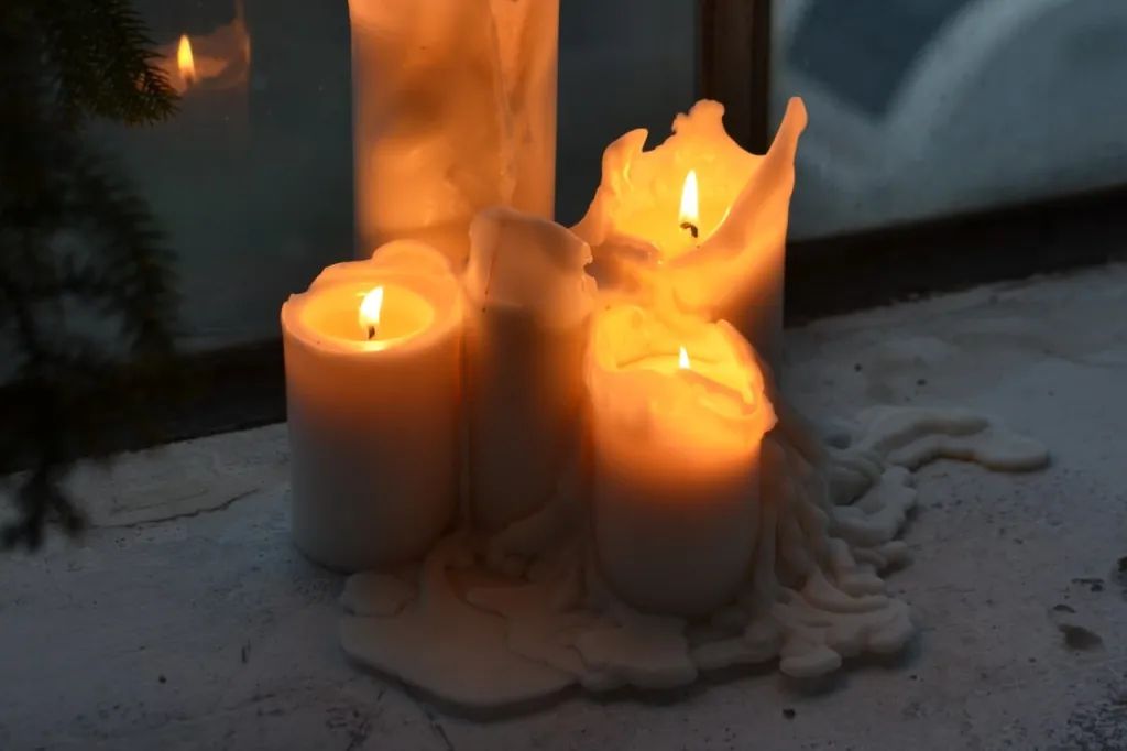 a tallow candle burning and emitting smoke