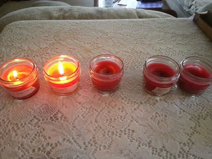 a wick being dipped into a borax solution before candle making.