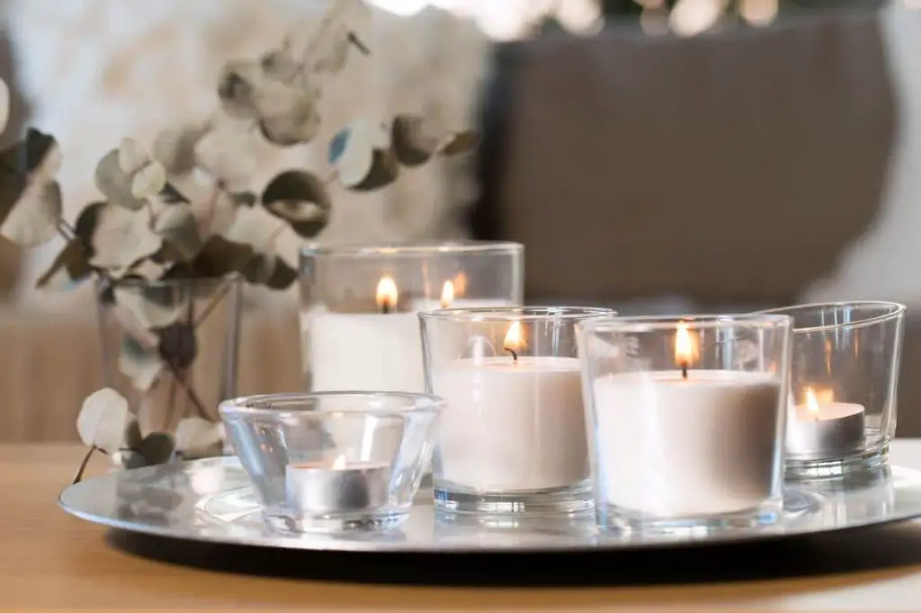 an assortment of differently sized and shaped candles including votives, pillars, tapers, and tealights.