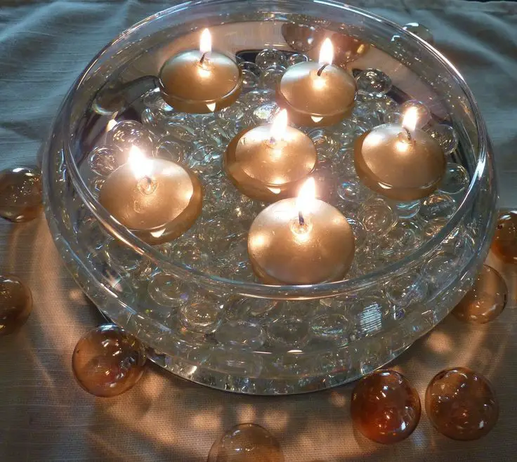 burning floating candle in a glass bowl.