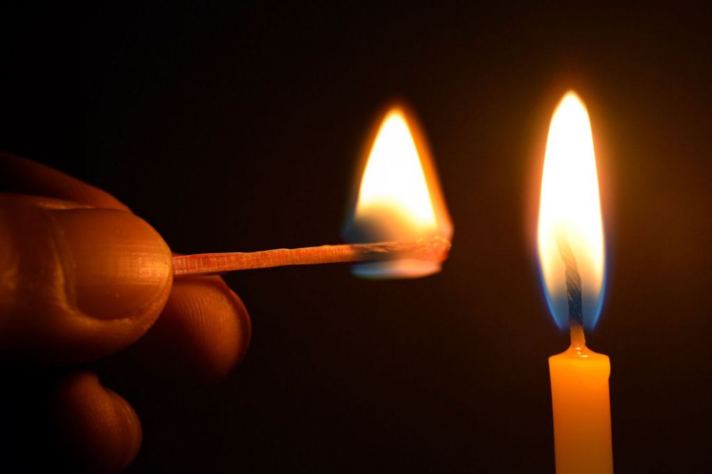 candle flames produce heat through combustion.