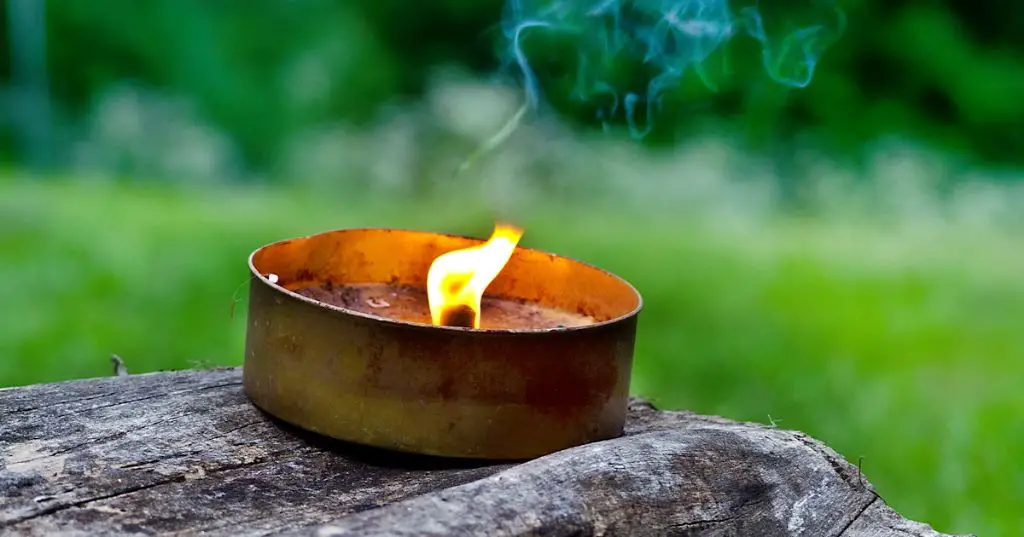 citronella candles burning on an outdoor patio table