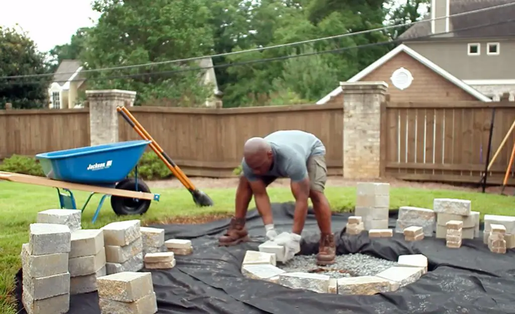 constructing a diy fire pit involves digging a shallow pit, adding drainage material, lining it with fireproof materials, and finishing the outer perimeter