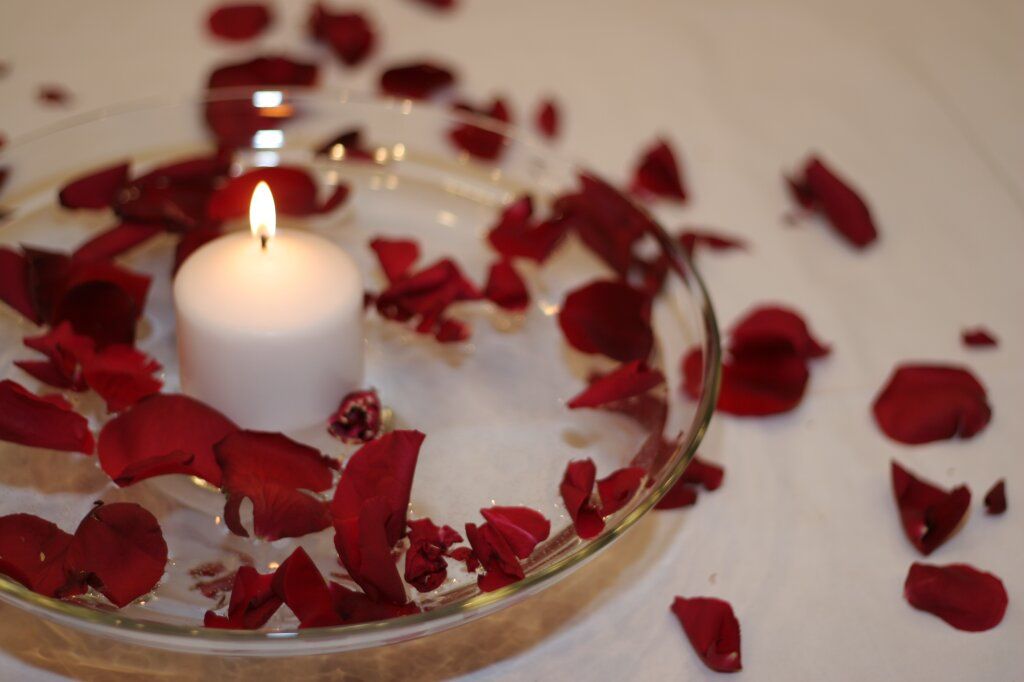 floating candles with flower petals floating in the wax.