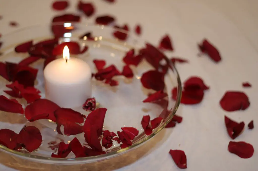 floating candles with flower petals floating in the wax.