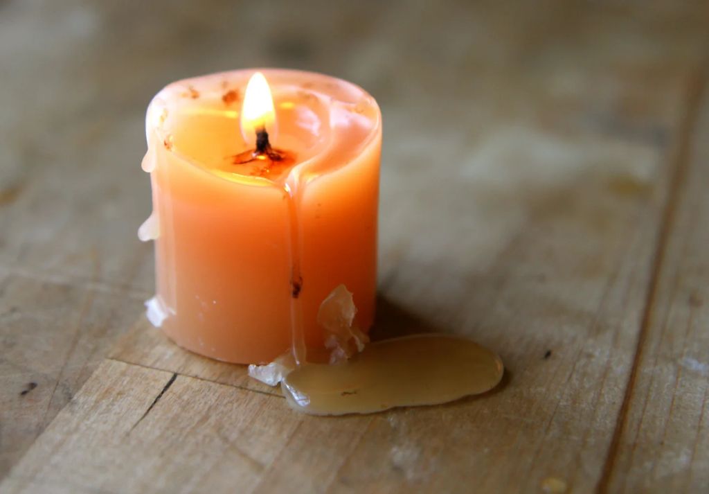 frozen recycled votive candle wax being removed from a mold