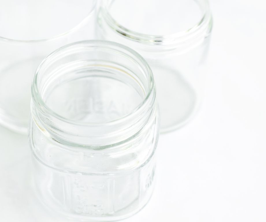 glass jars and metal tins for storing wax