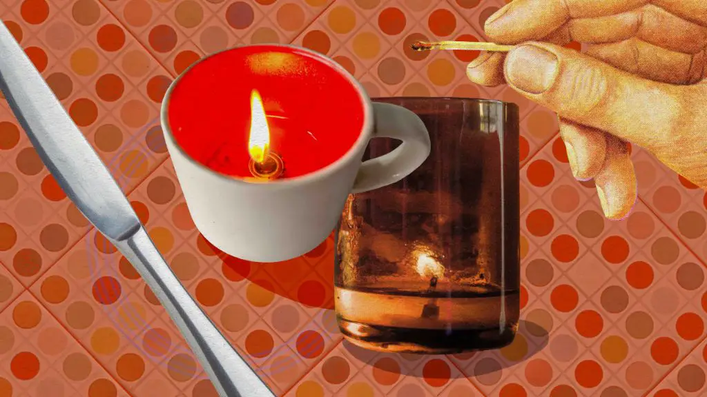 hot water and abrasive scrubbing helps remove stubborn wax residue from reused candle mugs.