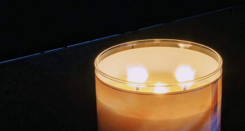 large candle with three wicks burning