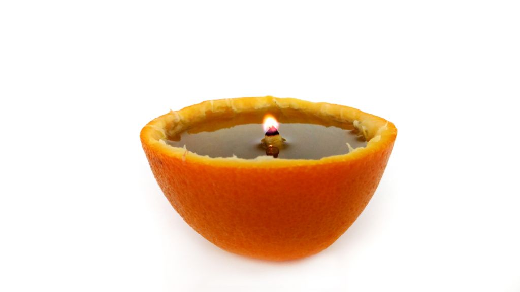 oranges contain flammable oils that can act as fuel for an improvised candle