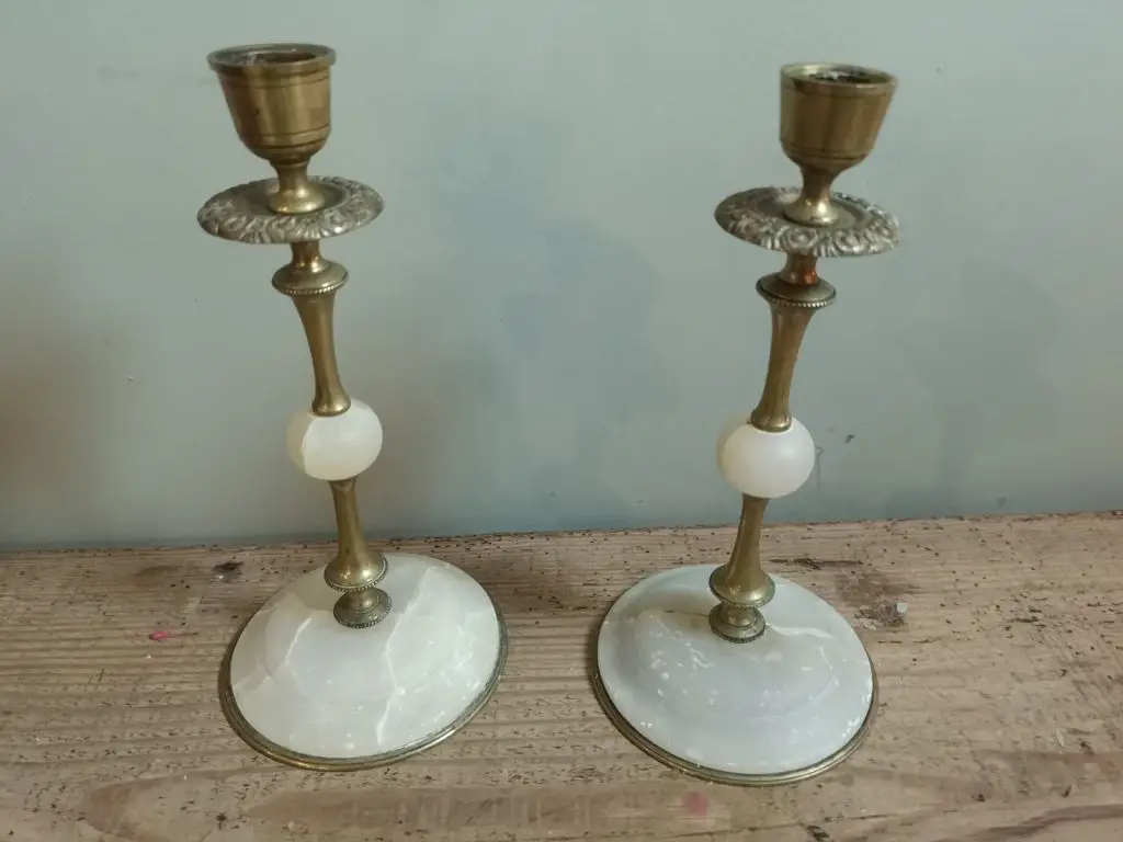 ornate antique brass candlesticks on a table