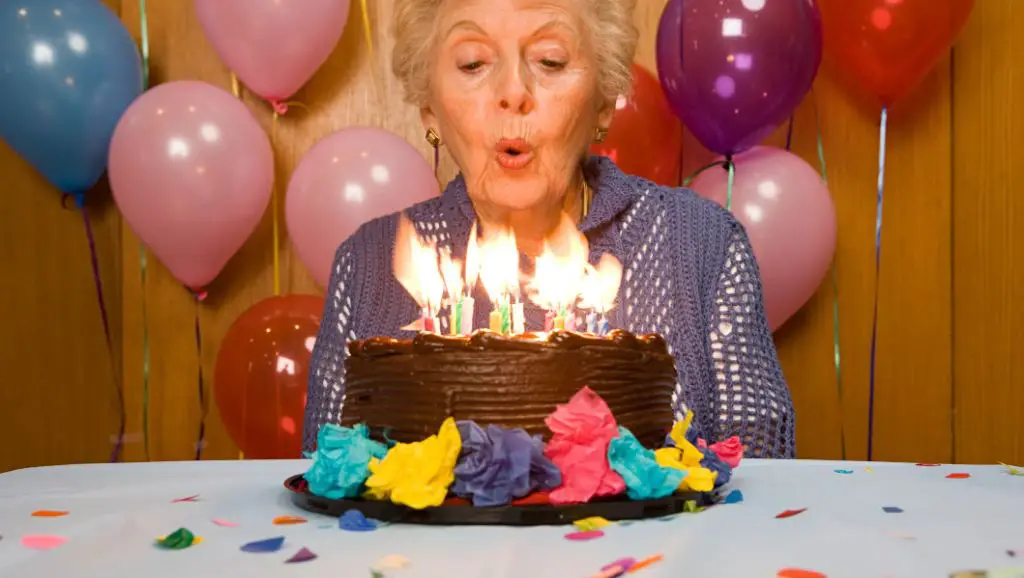 person blowing out a candle