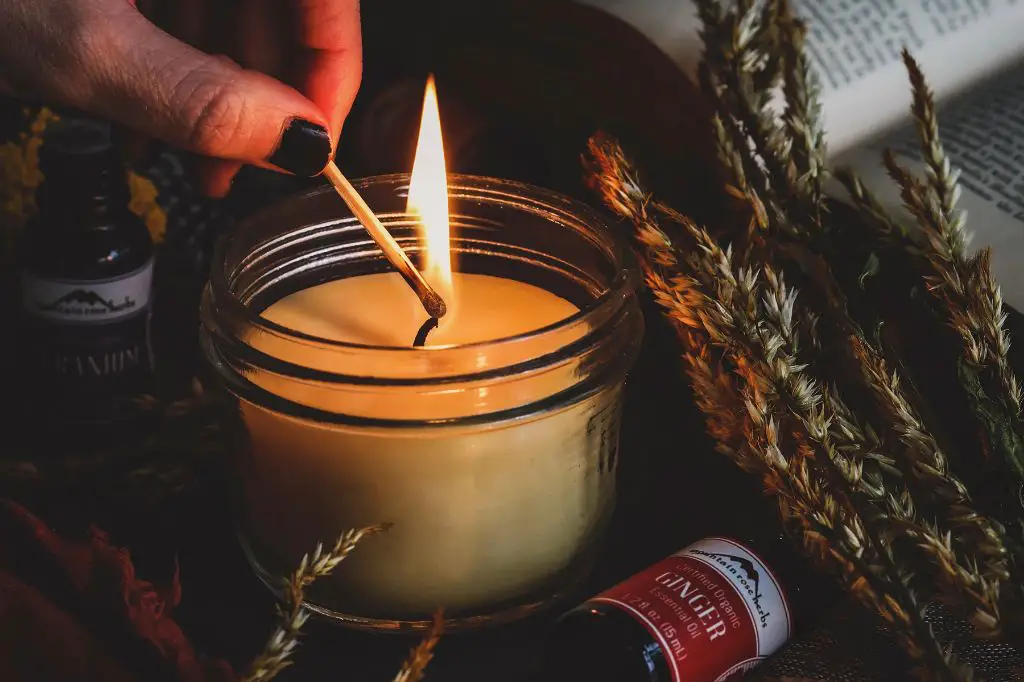 person selecting essential oils to make candles