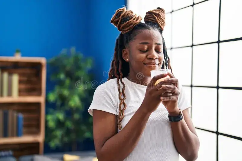 person smelling a scented candle