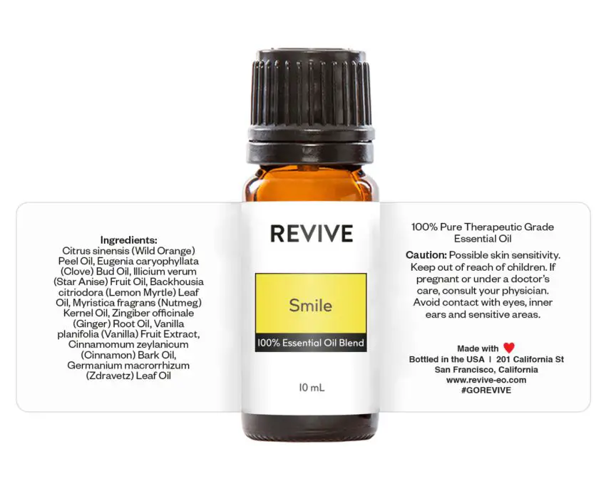 person smelling cinnamon bark essential oil with eyes closed and a smile.