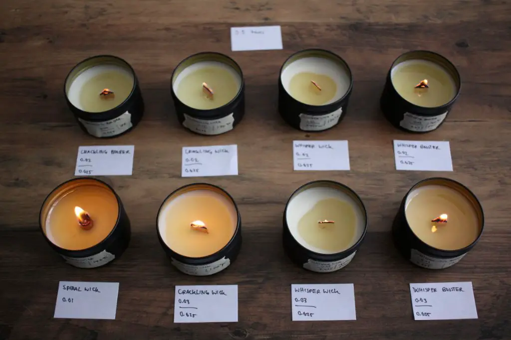 person testing different wick configurations in candles