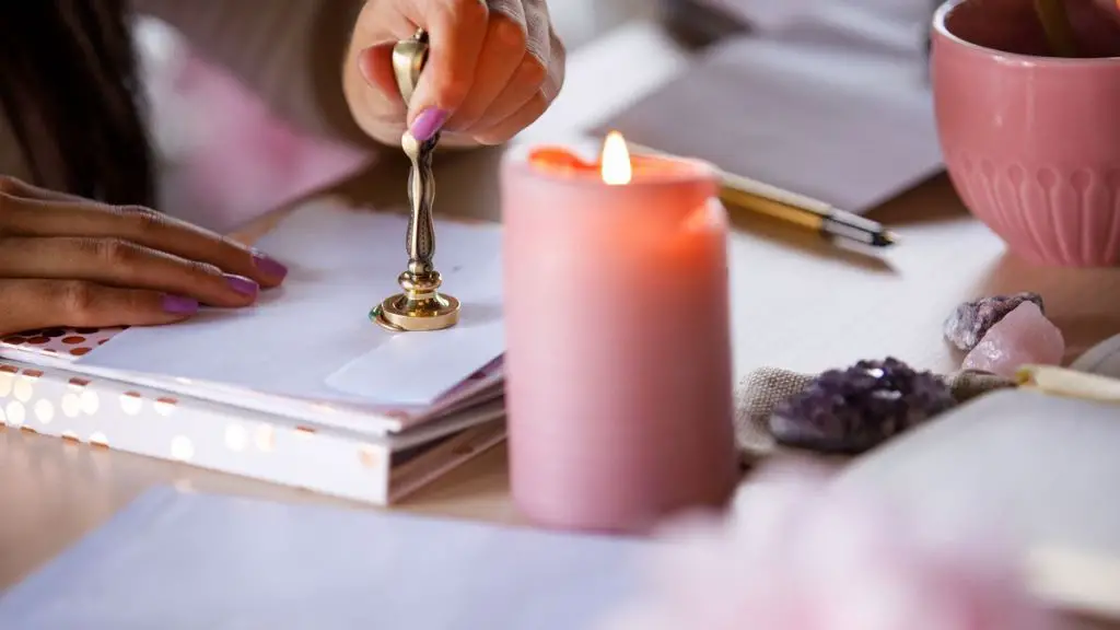 person weighing cost savings of reusing candle wax