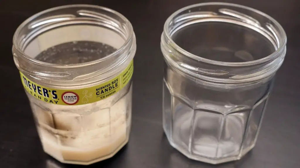 photo of pouring hot water into a used candle jar to melt wax