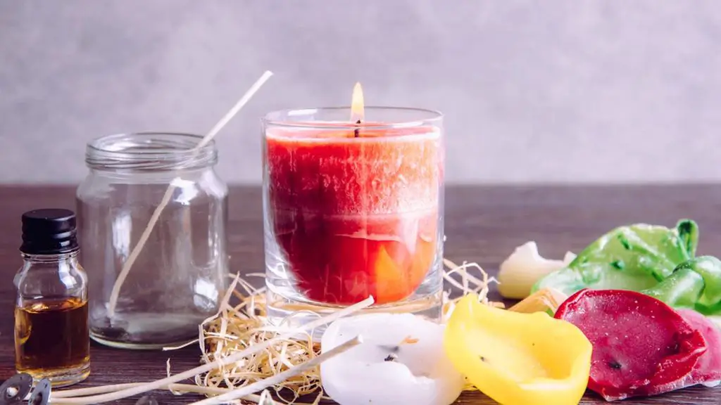 pouring hot wax into a glass jar