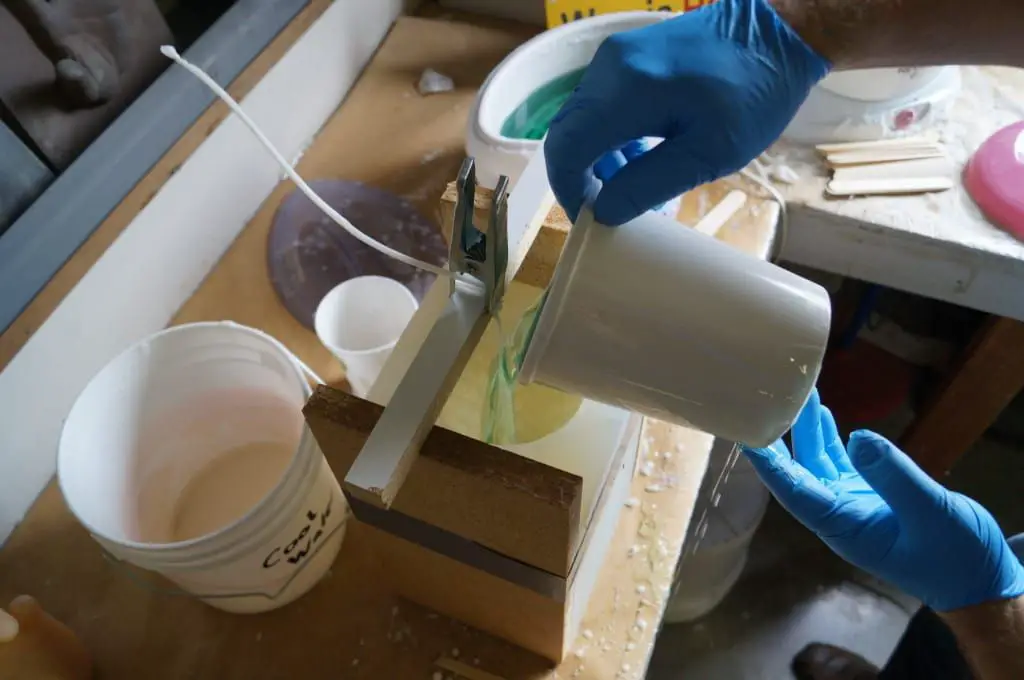 pouring soy wax into a silicone mold