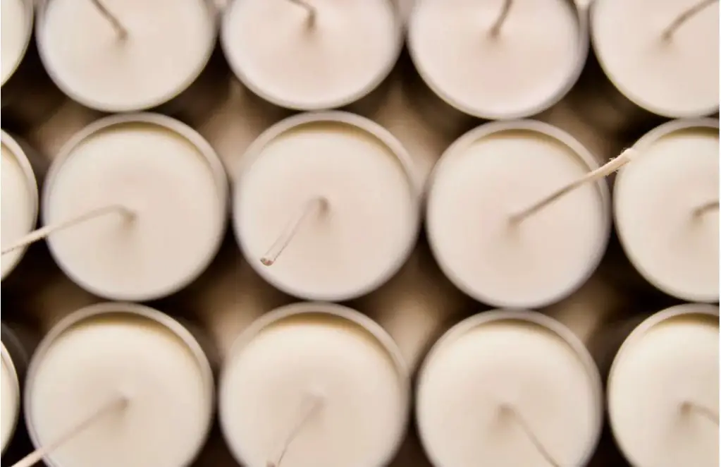 rows of soy candles curing on shelves.