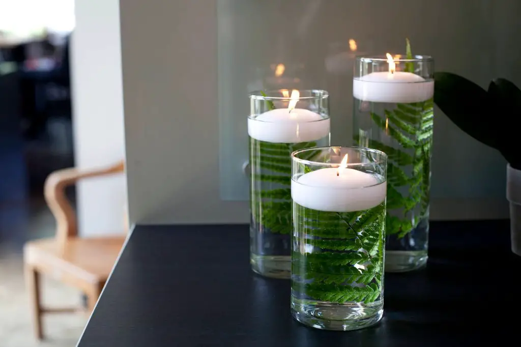 select wide, stable glass containers like hurricane vases, bowls, and jars to keep floating candles upright.