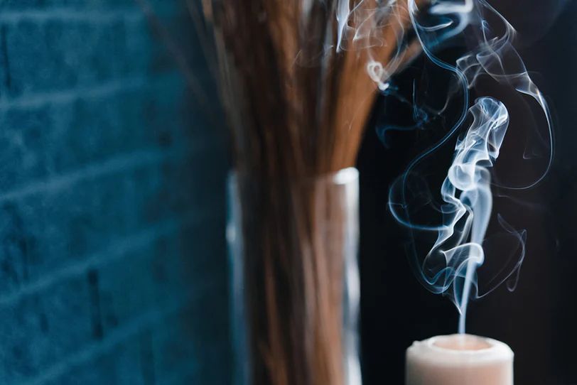smoke and soot coming off a burning candle