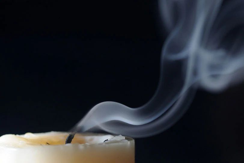 smoke or sparks from a candle wick indicates it's time to toss the candle.