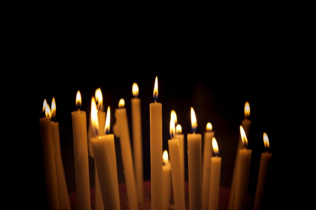 someone using a hair dryer to smooth out dripped wax on a burning candle