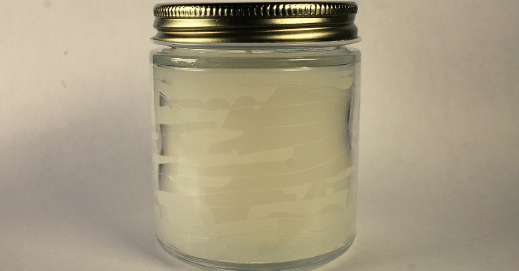 soy wax cooling in a glass container after melting